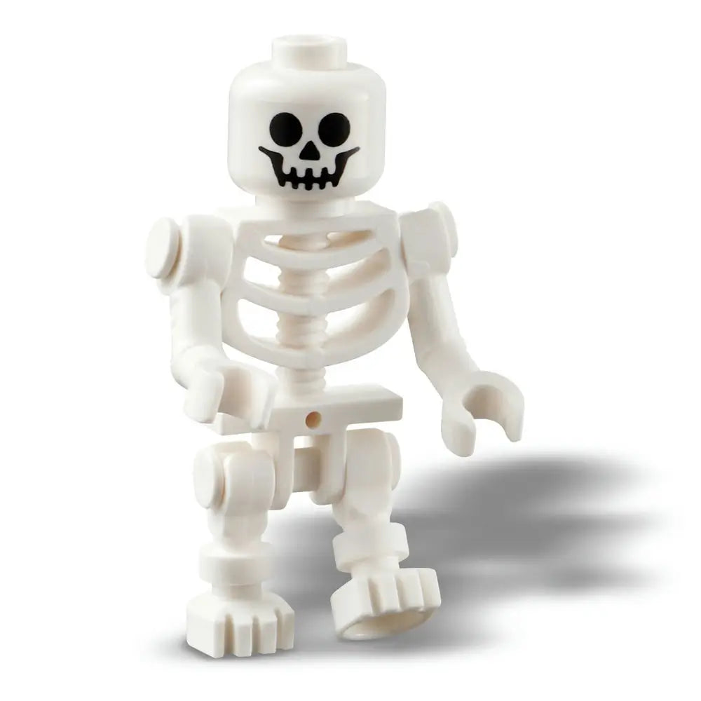 Close-up of a white LEGO skeleton minifigure with a smiling skull face and movable arms and legs, included as part of the Halloween Barn building set for spooky seasonal play.