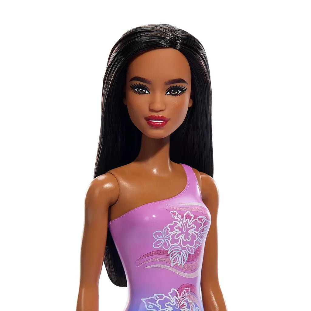 Close-up of Barbie beach doll with smooth dark brown hair, bright red lips, and a purple one-shoulder swimsuit decorated with detailed hibiscus floral graphics.