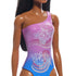 Detailed close-up of Barbie doll’s purple-to-blue gradient swimsuit featuring shiny material with two large hibiscus flower prints and flowing wave-like patterns.