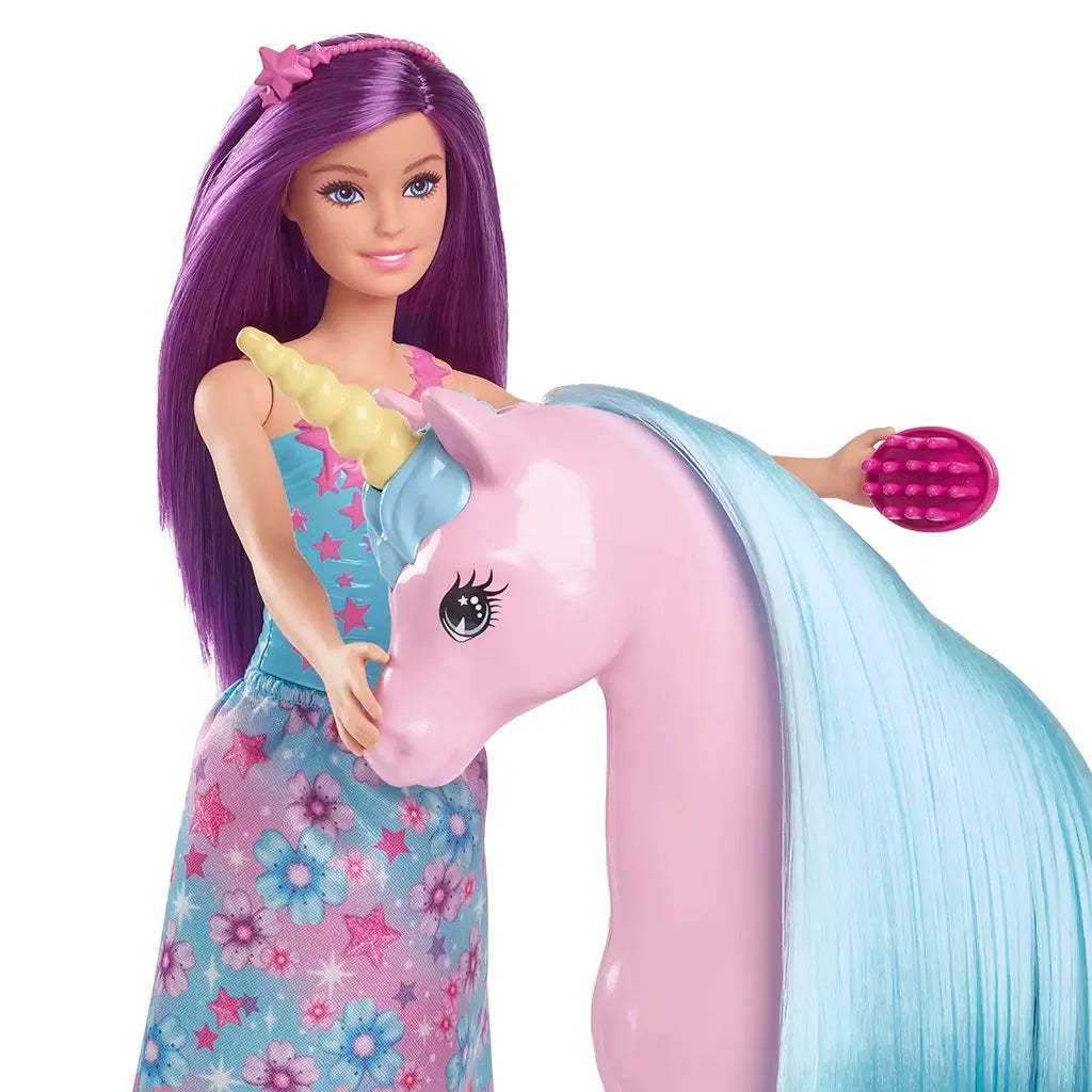 Barbie doll with purple hair and patterned dress brushes the pink unicorn toy’s long blue mane, highlighting the playset’s hair styling and interactive storytelling features.