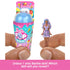 Close-up of Barbie Mini BarbieLand Pop Reveal with a hand holding a small 1.5-inch doll dressed in purple polka-dot top and skirt, shown next to the surprise cup container.