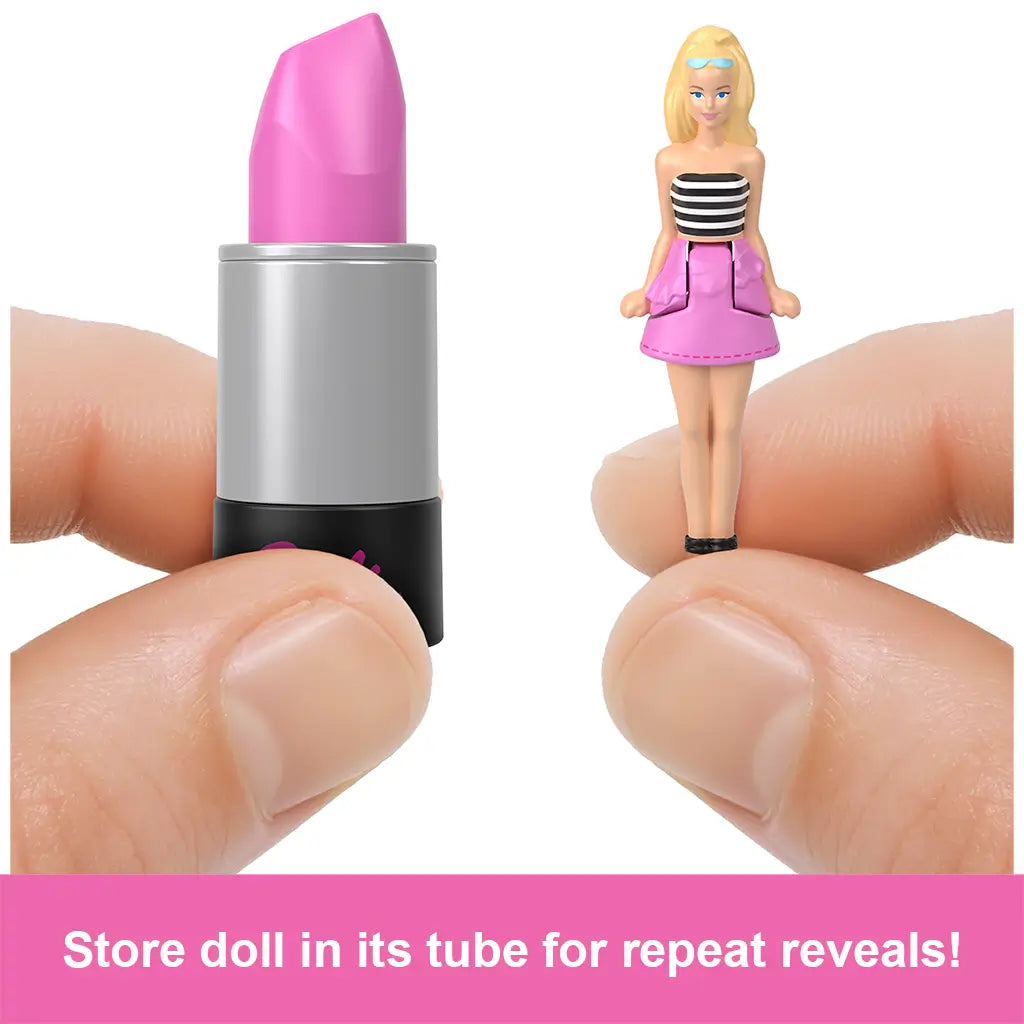Close-up of Barbie lipstick tube toy with tiny doll beside it, demonstrating how the collectible figure can be stored inside for repeated reveal play.