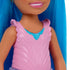 Close-up of Barbie Chelsea doll’s pink textured bodice with ruffled straps, featuring a molded blue heart pendant detail, shown with her bright blue hair framing the outfit.