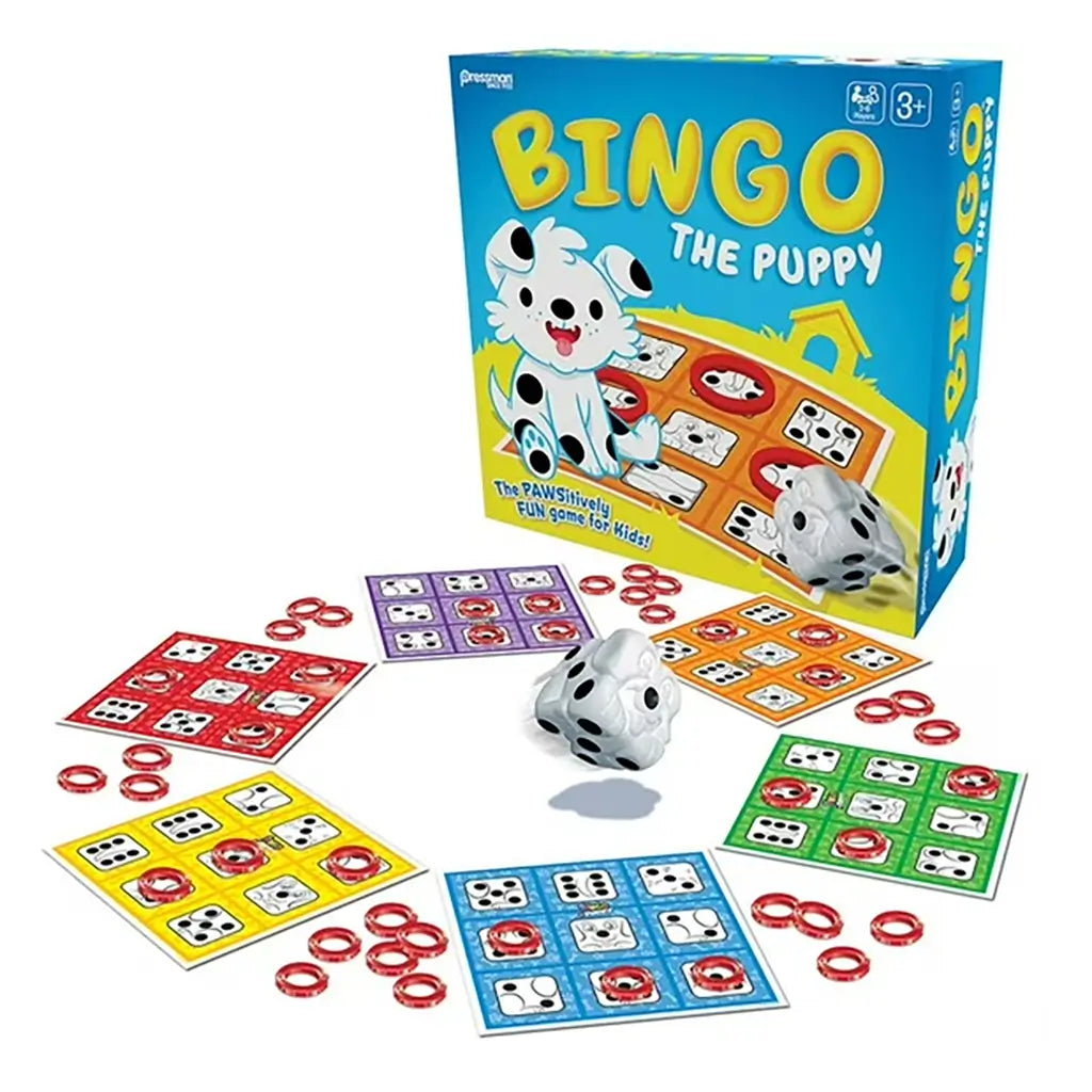 Complete Bingo The Puppy game set showing the box, multicolored bingo cards with puppy-themed spots, red ring markers, and a white puppy-shaped die in the center.