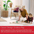 Child and adult playing together on floor with BRIO 65th Anniversary Train Set, showing wooden railway track, colorful train, and trees in a bright living room.