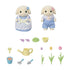 Calico Critters garden set shows two rabbit figures in gingham outfits with small tools, flower stems, colorful tulips, a watering can, and basket accessories displayed.
