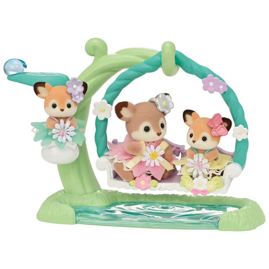 Calico Critters Deer Babies Floral Swing Set shown on plain white background with three baby deer in pastel dresses seated on a floral swing accessory with water-like base and playful details.