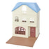 Calico Critters Sky Blue Terrace dollhouse stands three stories tall with cream walls, arched windows, blue roof, red front door, and fold-out brown play base for imaginative play.