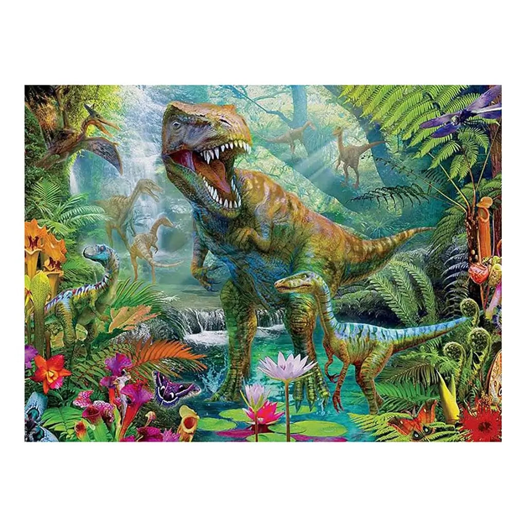 Ceaco Prehistoria puzzle design featuring a roaring T. rex and smaller dinosaurs in a lush, colorful jungle with waterfalls, tropical plants, and vivid flowers under dappled sunlight.