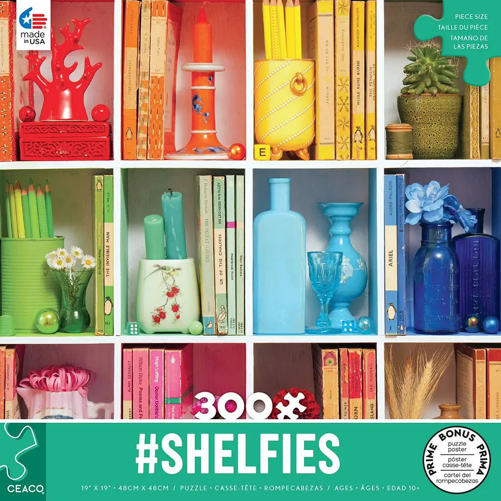Ceaco #Shelfies 300-piece puzzle box showing neatly arranged books, vases, candles, and plants on colorful cubby shelves, each section themed in coordinated hues of red, orange, yellow, green, and blue.