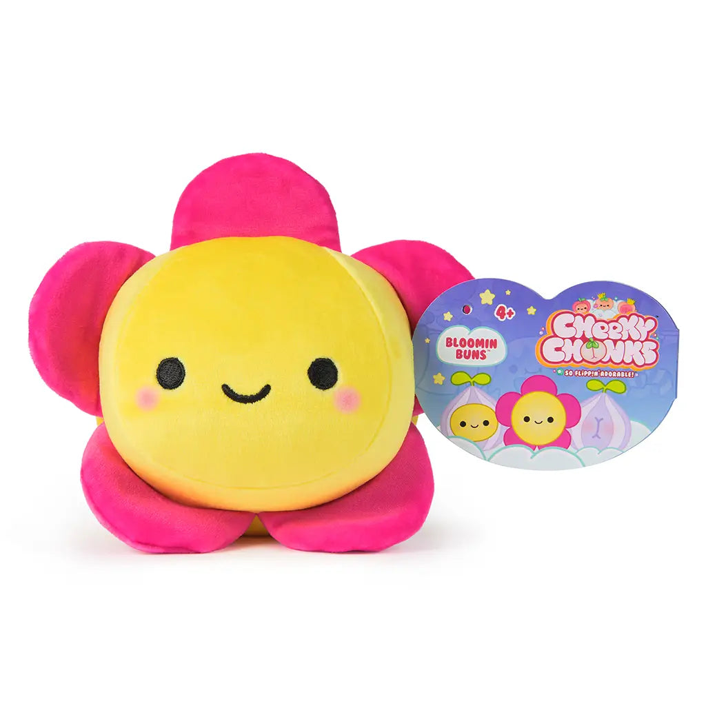 Front view of a Cheeky Chonks Bloomin Buns 6-inch plush flower toy with pink petals and yellow face, shown with heart-shaped retail tag featuring product branding.