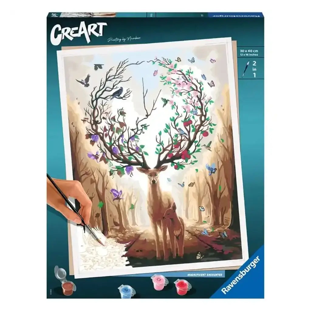 Ravensburger CreArt paint by numbers kit box showing a woodland deer with antlers shaped like blooming branches, accompanied by butterflies, with a hand painting sections of the canvas.