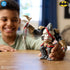 Smiling boy plays with DC Comics Gorilla Grodd Ninja Strike action figure, showcasing its swinging weapon feature and posable limbs for dynamic superhero play.