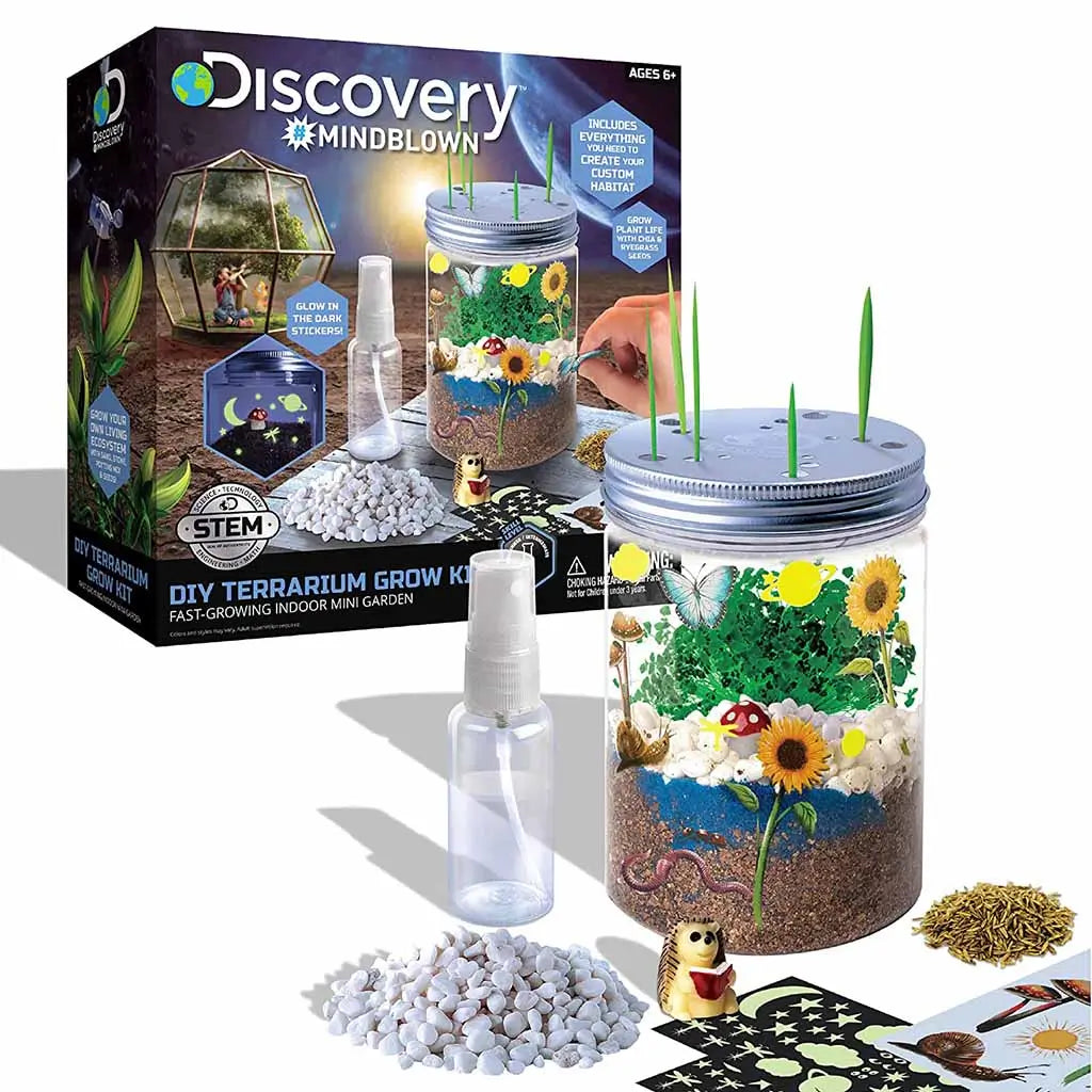 Discovery Mindblown DIY Terrarium Grow Kit with open contents including jar, spray bottle, soil, seeds, stones, and stickers for creating a mini indoor garden with glow-in-the-dark features.