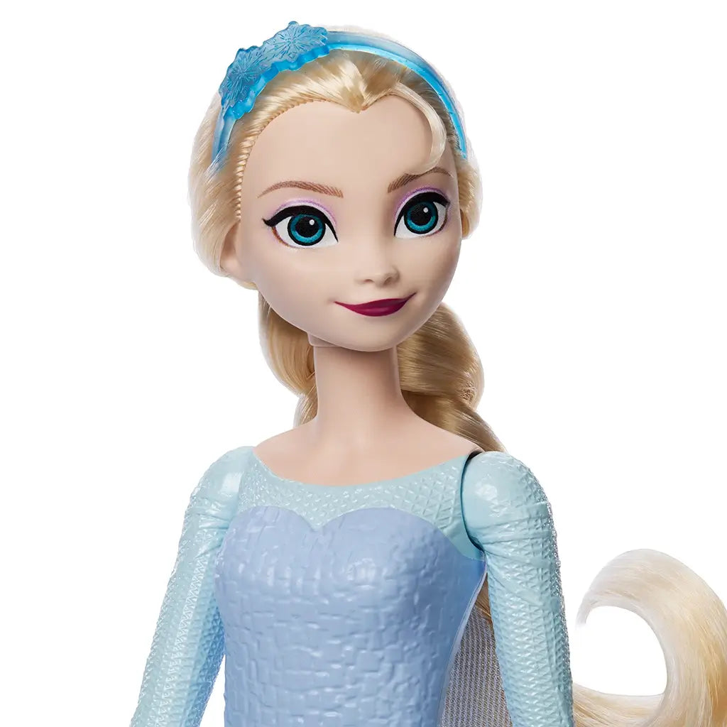 Disney Frozen Elsa doll close-up with bright blue eyes, pale blonde hair, and icy blue textured dress, wearing a snowflake headband for magical storytelling and imaginative play.