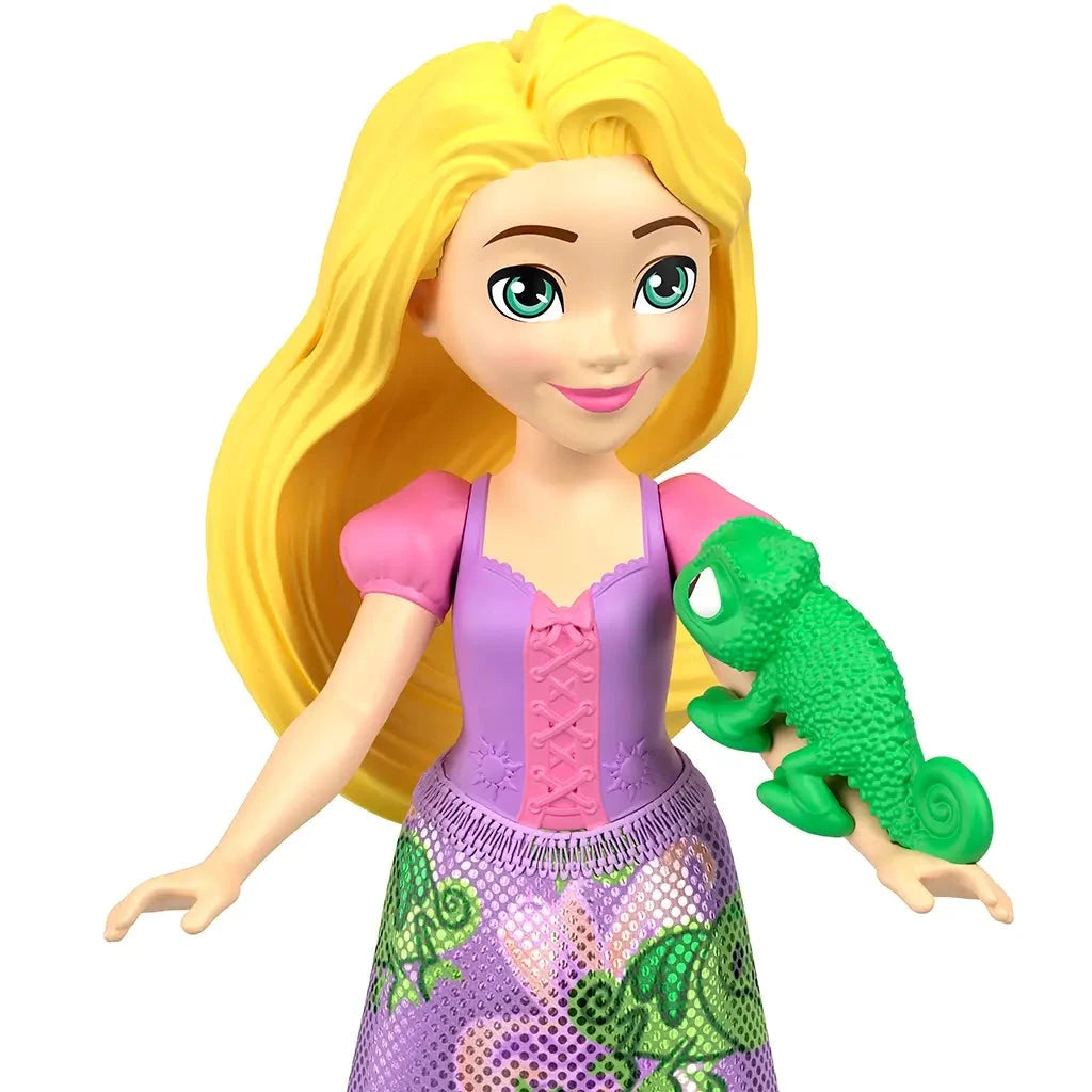 Rapunzel doll from Disney Princess Friends set holding green chameleon Pascal, wearing a pink and purple dress with character-themed skirt print.