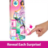 Hand opening numbered door on Disney Princess Spin & Reveal Jasmine doll packaging to uncover hidden surprise accessory.