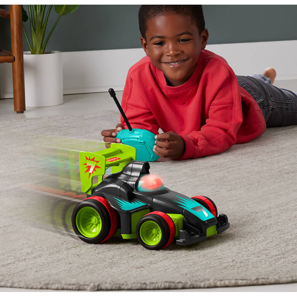 Image of a boy wearing red shirt playing Fisher-Price My Easy RC Remote Controlled Car