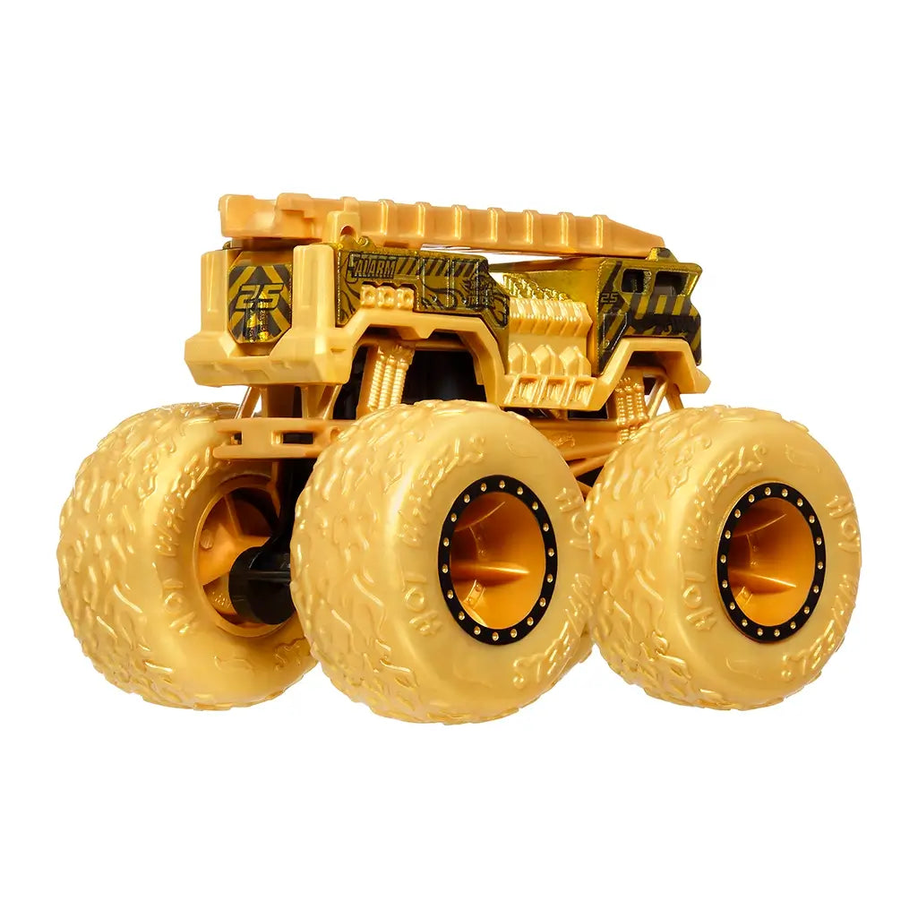 Rear angle of Hot Wheels 5 Alarm monster truck in gold finish, showing oversized wheels, rear detailing, and textured bodywork.