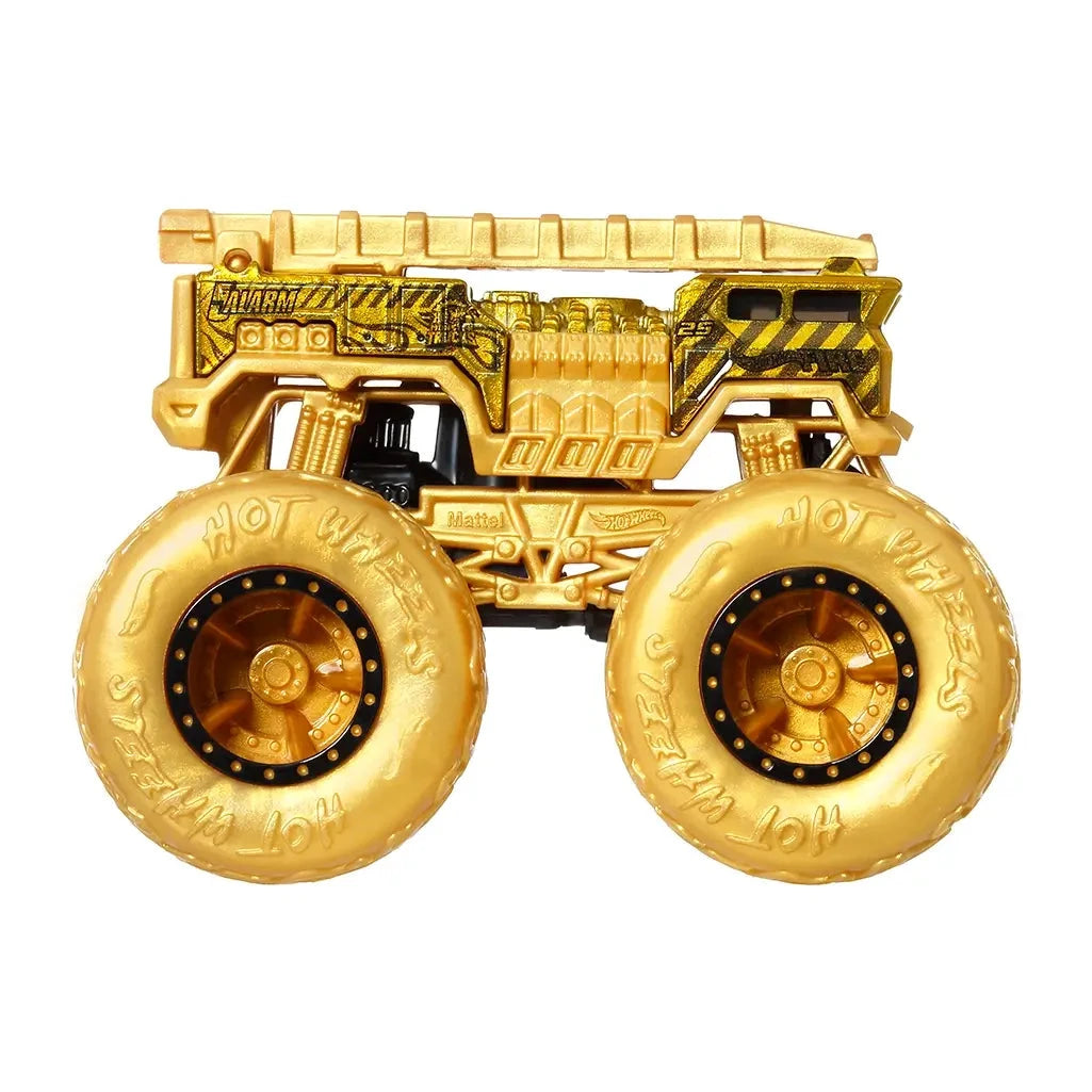 Side view of gold Hot Wheels Monster Trucks 5 Alarm fire brigade vehicle with flame-textured tires and detailed emergency graphics.