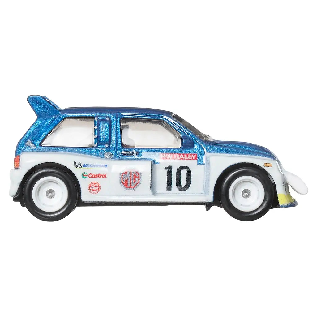 Side profile of Hot Wheels MG Metro 6R4 toy car in blue and white with rally livery, large rear wing, number 10, and sponsor logos like Castrol and Michelin.