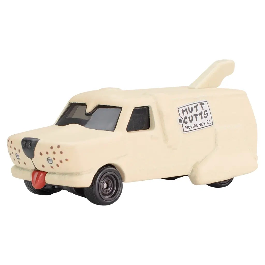 Beige Hot Wheels toy van modeled after the Dumb and Dumber 'Mutt Cutts' dog van, with a red tongue front detail, black wheels, side logo, and sculpted fur-like texture.