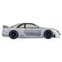 Side profile of Hot Wheels Premium Nismo GT-R LM in metallic silver, showcasing aerodynamic coupe shape, extended side skirts, tinted windows, and black wheels with blue trim.
