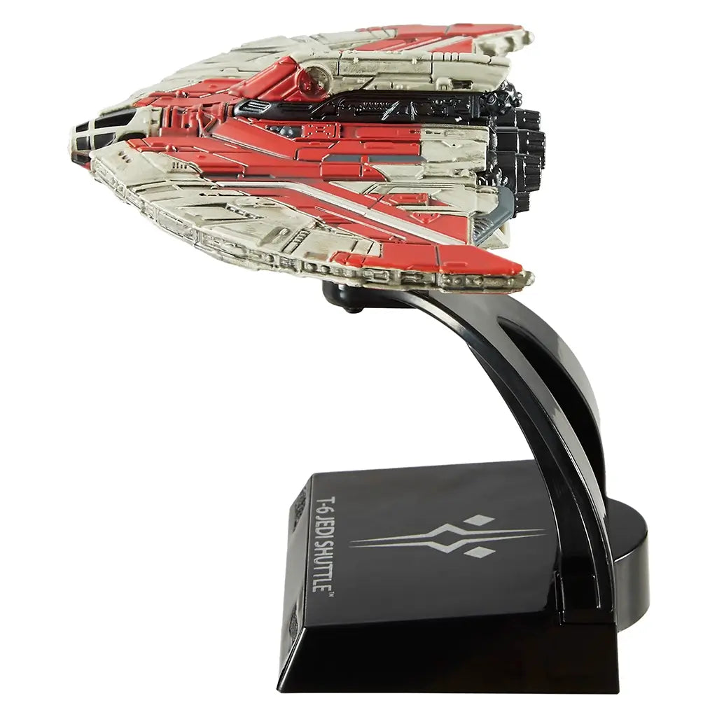 Side profile of Hot Wheels Star Wars Ahsoka Tano’s T-6 Jedi Shuttle 1:50 scale toy ship, mounted on a black display stand with intricate molded details and red-accented wing panels.