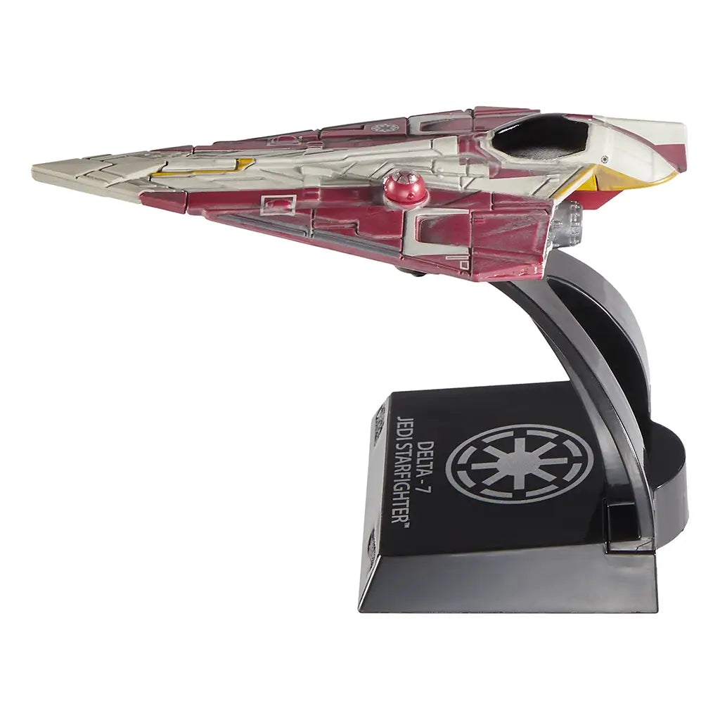 Side view of Hot Wheels 2025 Obi-Wan Kenobi’s Jedi Starfighter die-cast collectible featuring a triangular design, red astromech droid, Republic logo, and slim nose detail, posed on a collector’s base.
