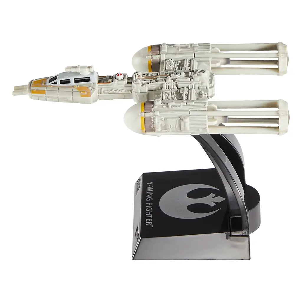 Side profile of the Hot Wheels 2025 Y-Wing Fighter die-cast toy, highlighting the signature elongated twin-engine design, yellow cockpit markings, and detailed bodywork mounted on a display base.