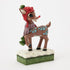 Detailed Rudolph figurine wearing red knit hat, green pom-pom, and purple scarf, standing on snowflake base with textured green edge, angled view from the front side.
