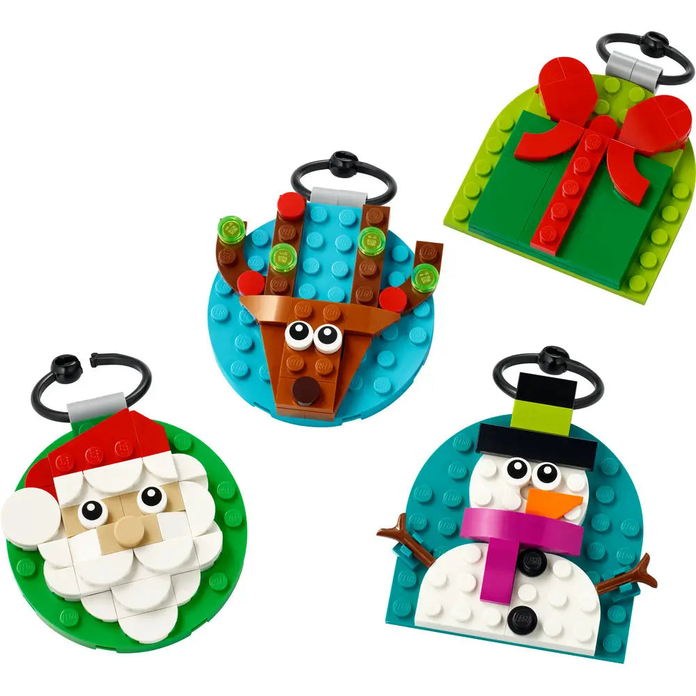 Close-up view of LEGO Christmas ornaments showing Santa, a reindeer, a snowman, and a gift design ready to hang on a Christmas tree.