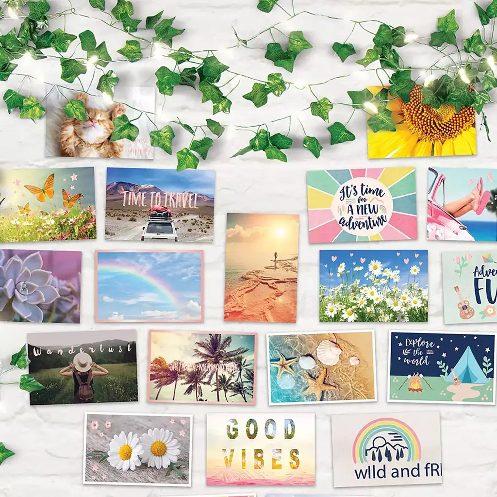 Close-up of 3C4G wall collage showing vibrant travel and nature-themed cards like rainbows, flowers, and sunsets, surrounded by glowing ivy fairy lights.