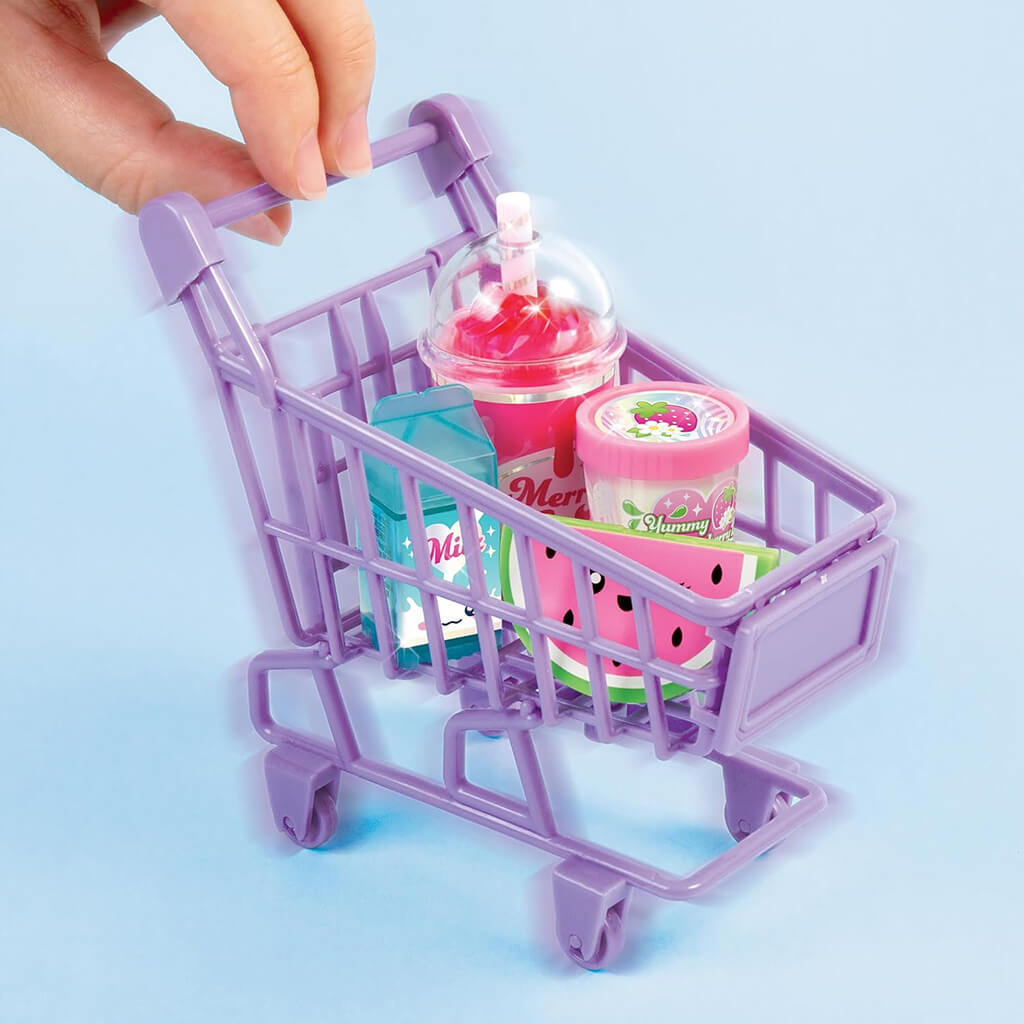 Bright lavender plastic shopping cart toy holding mini lip glosses shaped like drinks and desserts, set against a light blue background for a colorful cosmetic product display.