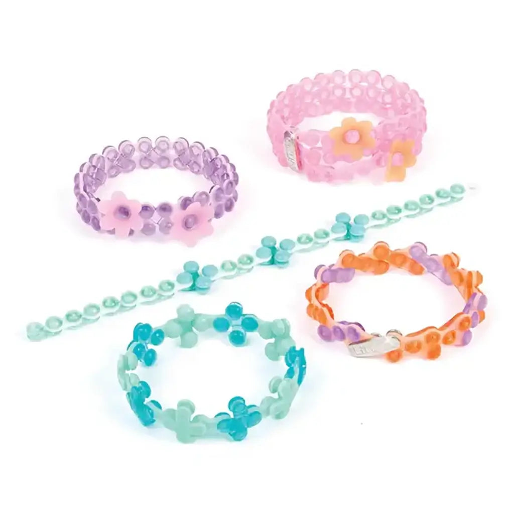 Colorful Linxo celebration-style bracelets made from translucent plastic beads in pastel purple, pink, teal, and orange tones, arranged in flower patterns on a white background, promoting creative jewelry design.