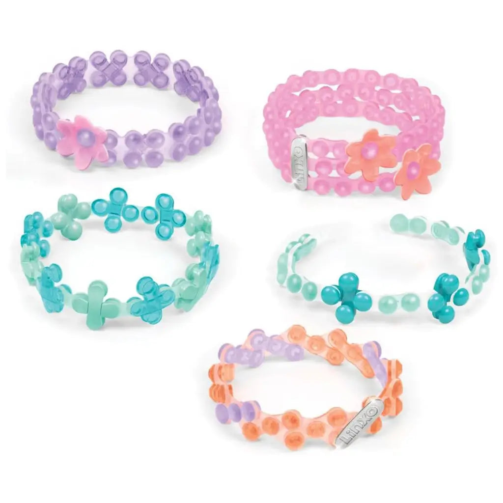 Linxo Seaside Style Jewelry Design Set featuring five handmade bracelets in pastel blue, pink, orange, and lavender tones with floral accents and flexible connectors.