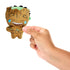Hand holding Marvel Moodiverse Series 1 Laughing Groot plush, small soft brown figure with stitched smiling face, blue embroidered tears, and green crown detail for scale.