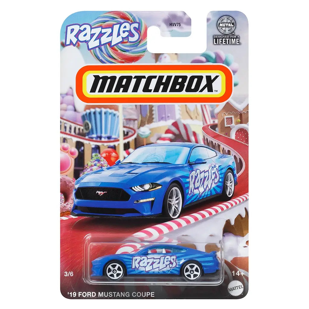 Matchbox Razzles ’19 Ford Mustang Coupe toy car in metallic blue with bold white “Razzles” logo, displayed in candy-themed packaging featuring lollipops and gingerbread details.