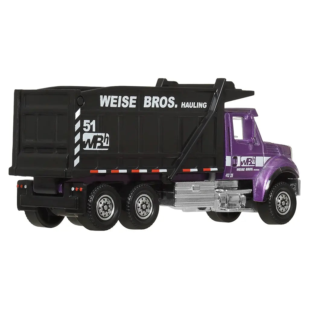 Matchbox International WorkStar 7500 Dump Truck diecast in 1:64 scale, purple cab, chrome bumper, black dump bed with Weise Bros. Hauling branding, shown from rear angled view.
