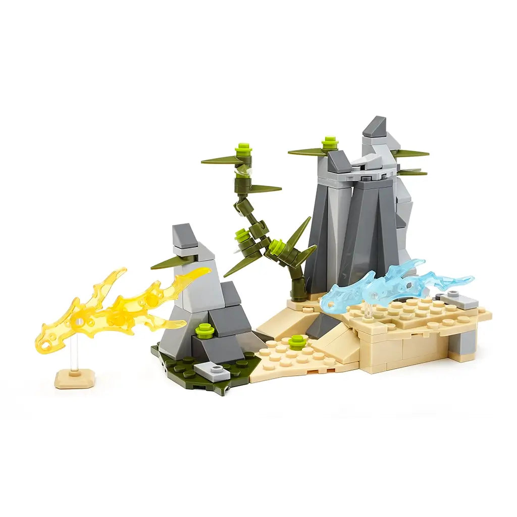 Mega Construx Pokémon set showing a tan and gray rocky battle arena with green plant details and transparent fire and water attack effects for imaginative play.