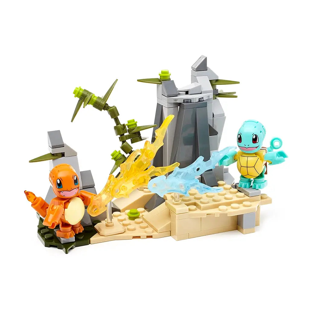 Mega Construx Pokémon Squirtle and Charmander figures in a rocky terrain with water and fire blasts, compatible with other Pokémon construction building sets.