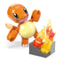 Close-up of Mega Pokémon Charmander figure from the Fire-Type Spin building set, showing its articulated limbs and tail posed beside translucent orange and yellow plastic flames.