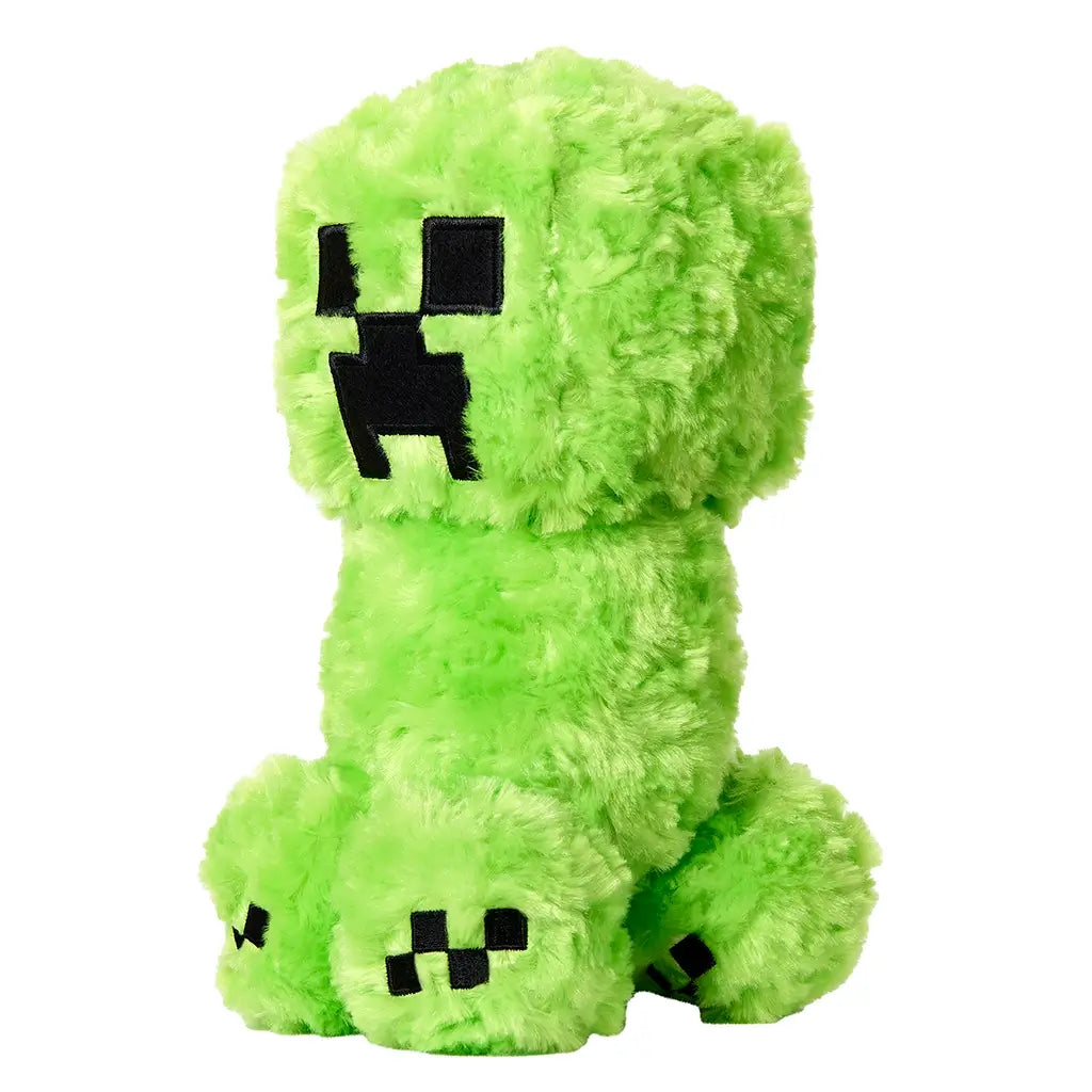Plush toy of Minecraft Creeper in vibrant green fuzzy fabric with black stitched square eyes and mouth, shown upright in angled side view on white.