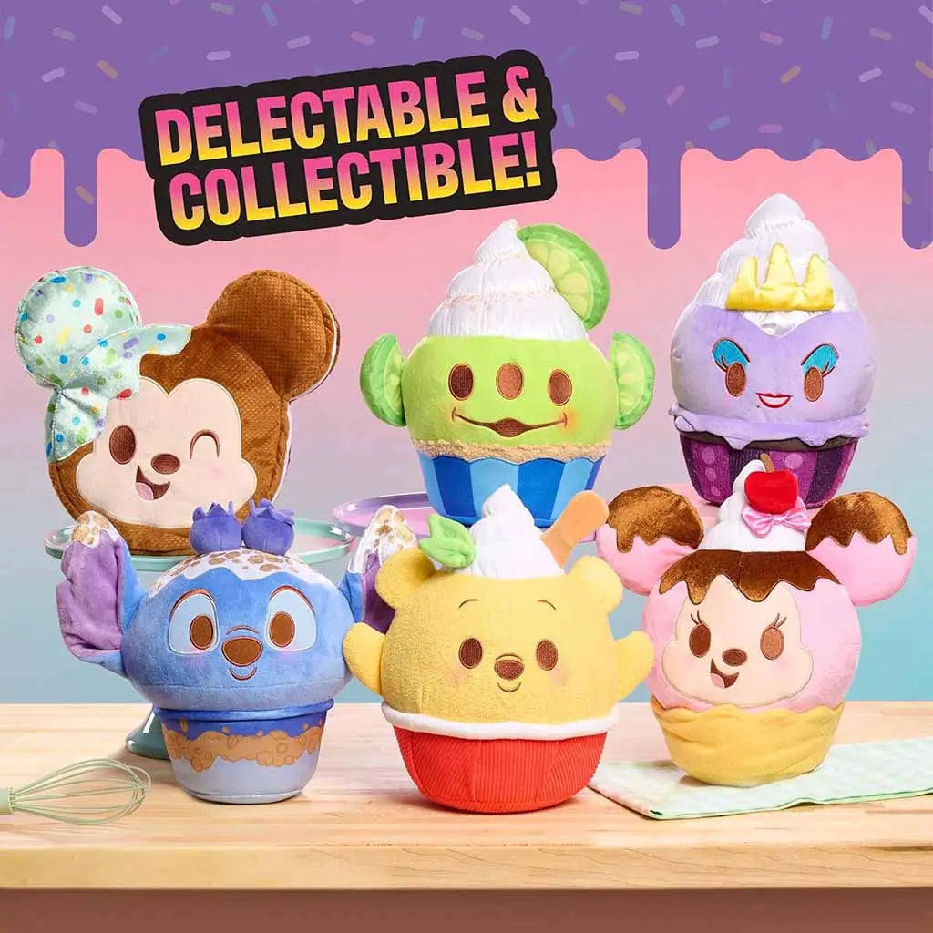 Collection of Disney Munchlings plush cupcakes including Toy Story Alien, Mickey, Stitch, Pooh, and Ursula, shown on a pastel tabletop with colorful text that reads ‘Delectable & Collectible!’