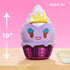 10-inch Disney Munchlings Ursula plush from The Little Mermaid shown against a pink backdrop with a height arrow and text for ages 0+, displaying its purple cupcake base and yellow satin crown.