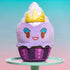 Disney Munchlings Ursula plush cupcake toy resting on a mint cake stand with a gradient blue-to-pink background, showing purple icing, shiny white swirl, and soft golden crown on top of its smiling face.