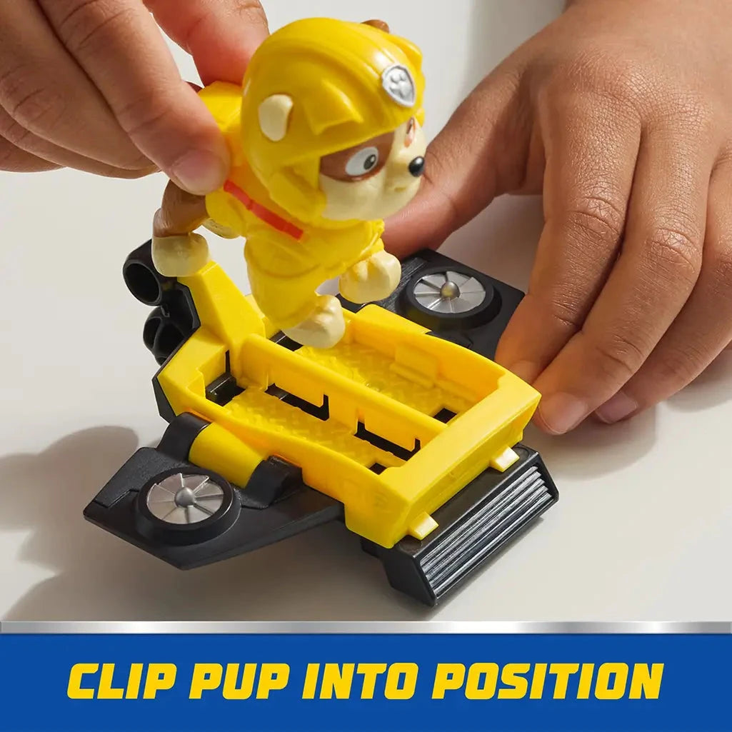 Child clips PAW Patrol Rubble figure into yellow hoverboard with black fans, demonstrating secure placement and action-ready setup.