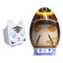 PhatMojo Pet Simulator Series 2 white cat toy with blue eyes beside a black and gold egg with closed eyes and ornate details, displayed on blue base stand.