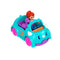 Polly Pocket red-haired doll driving a teal triceratops-shaped toy car with pink wheels, accompanied by a purple brontosaurus passenger, both sitting inside the two-seater vehicle.