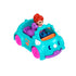Polly Pocket red-haired doll driving a teal triceratops-shaped toy car with pink wheels, accompanied by a purple brontosaurus passenger, both sitting inside the two-seater vehicle.